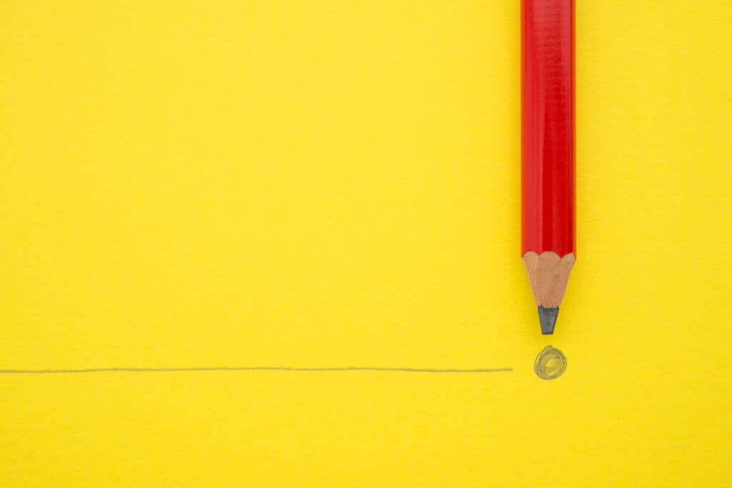 Black pencil write the end point on yellow paper background with copy space. Concept of conclusion, completion and successful in business target.